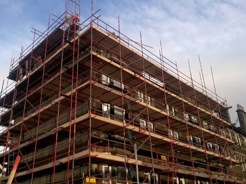Residential building enclosed by access scaffolding